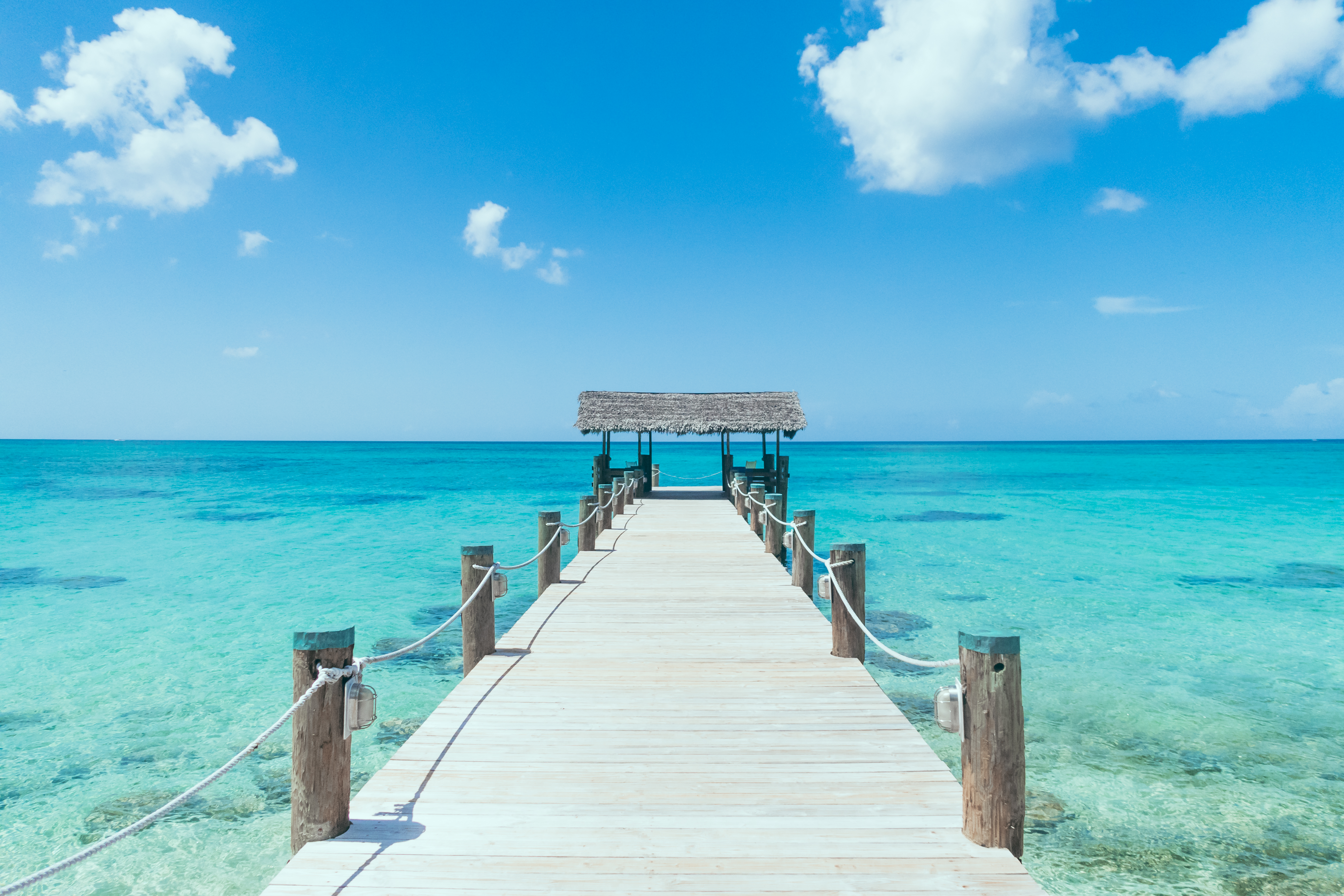 Island Pier On Perfect Tropical Beach With Blue Water.jpg