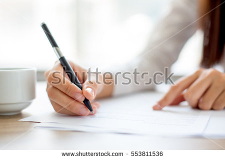 stock-photo-hand-of-businesswoman-writing-on-paper-in-office-553811536.jpg