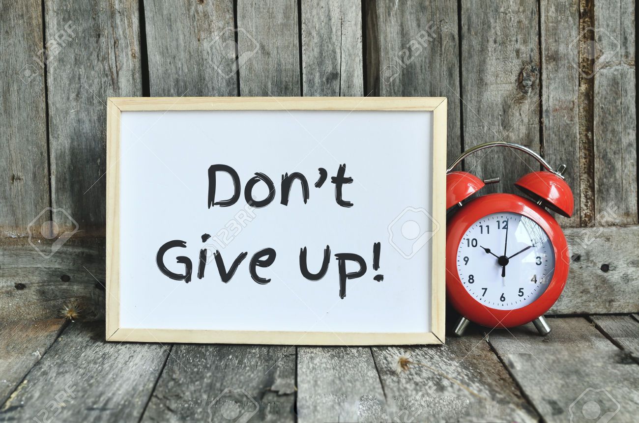 38070475-Don-t-give-up-message-note-on-white-board-with-red-retro-clock-on-wooden-background--Stock-Photo.jpg
