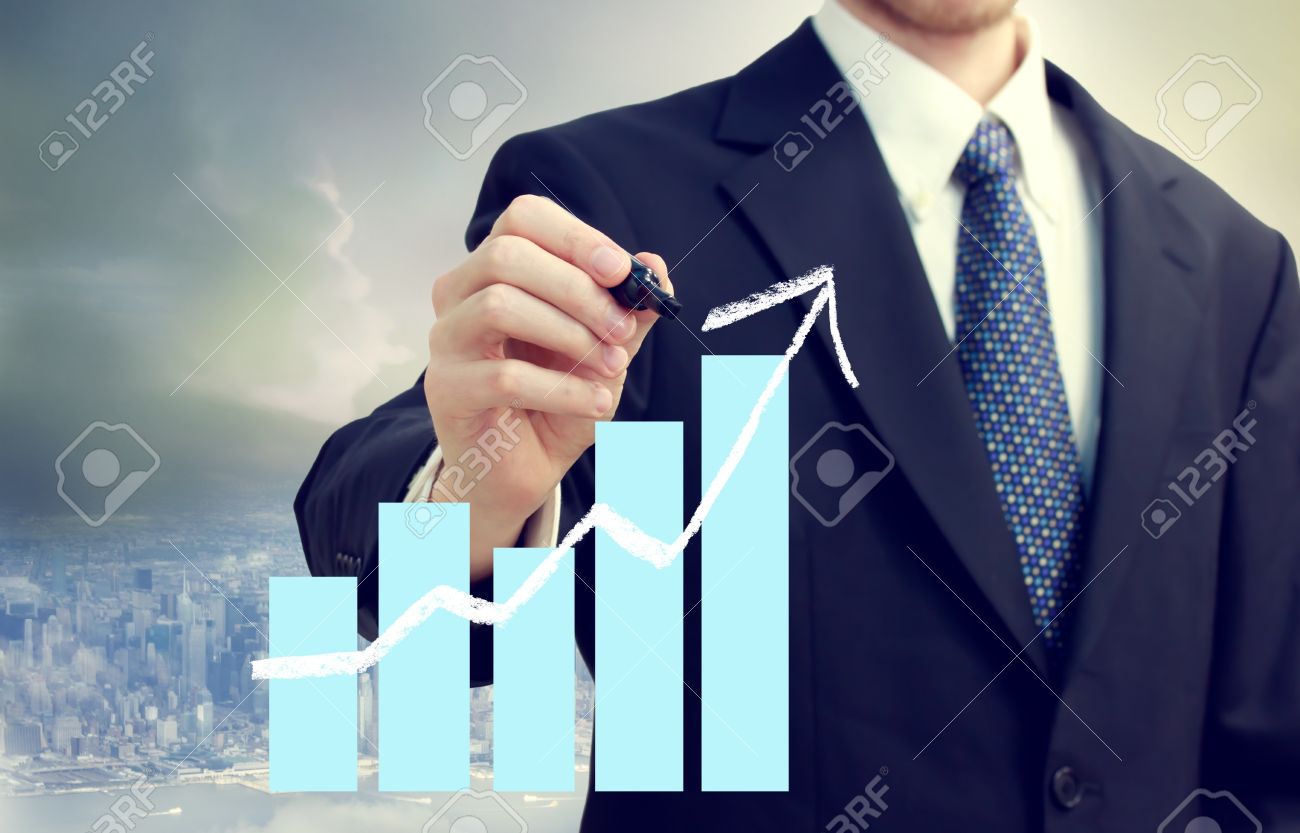 15816043-Business-man-with-a-chart-showing-growth-with-city-background-Stock-Photo.jpg