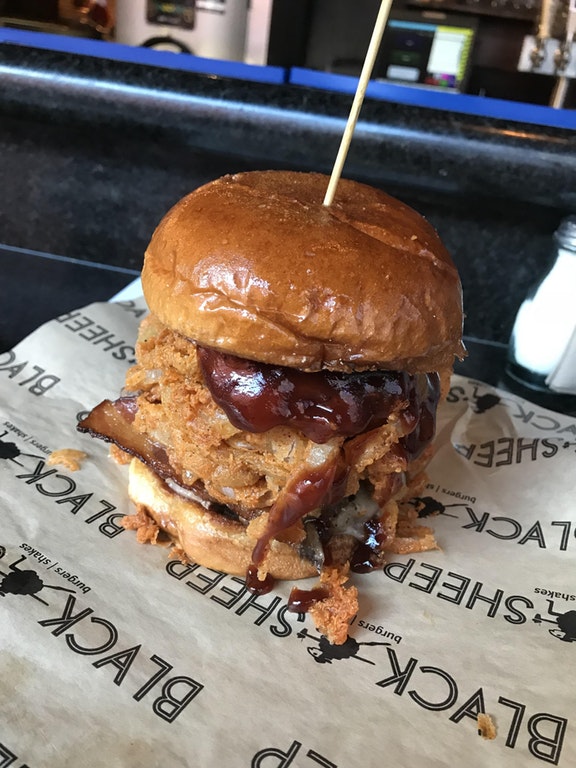 Cowboy Carl burger topped with smoked brisket, cheddar, bacon, fried onions, and BBQ sauce.jpg