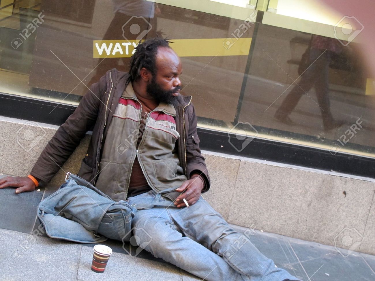 1506414993677_12273152-a-beggar-on-a-street-in-Madrid-Spain-Stock-Photo.jpg