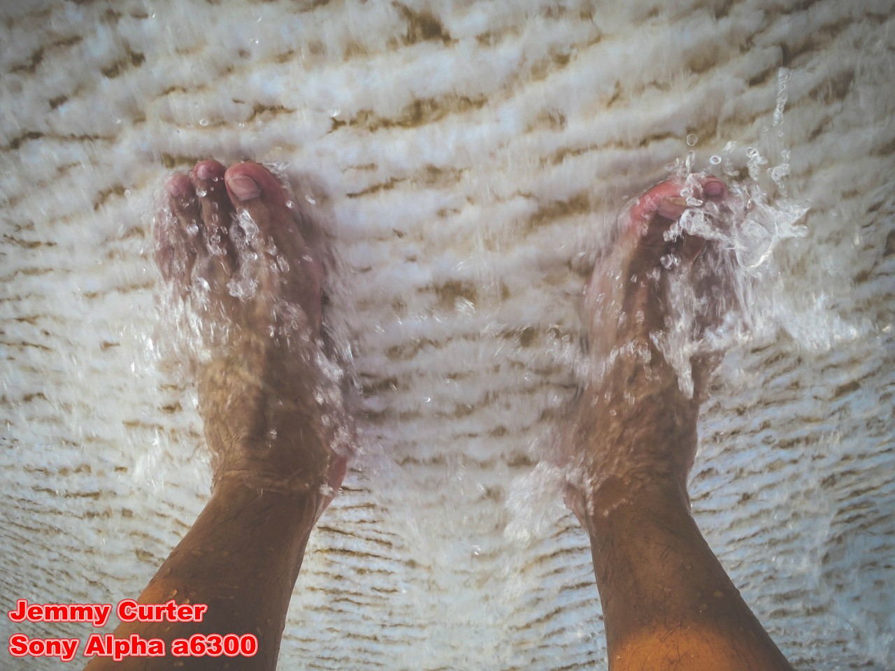 139.Water washes over his feet in the travertine pools..jpg