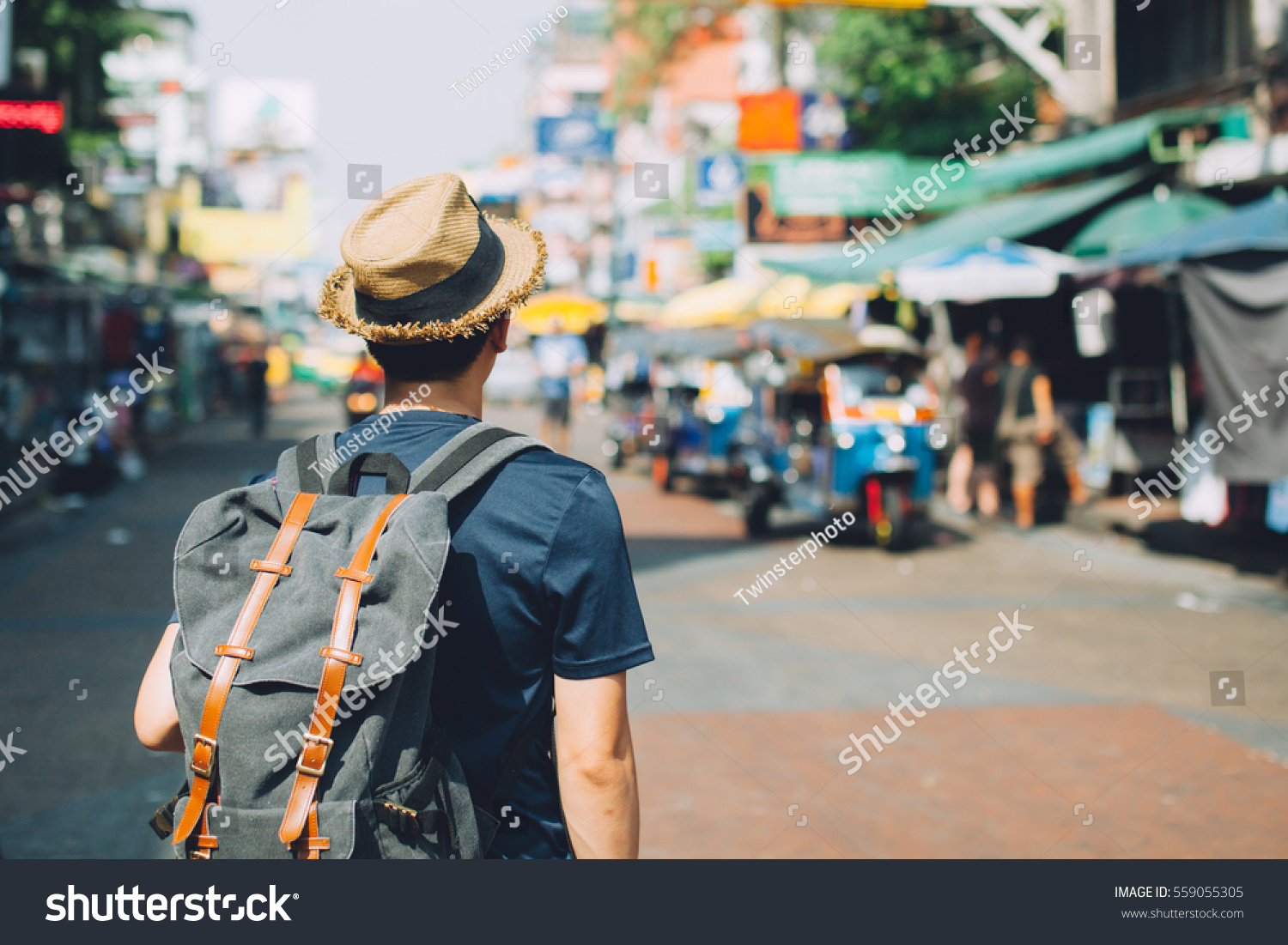 stock-photo-young-asian-traveling-backpacker-in-khaosan-road-outdoor-market-in-bangkok-thailand-559055305.jpg