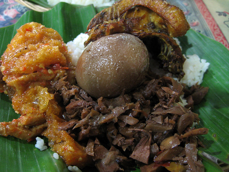 Gudeg (brown, with egg) with krecek (orange) and fried chicken from Wikimedia https://commons.wikimedia.org/wiki/File:Nasi_Gudeg.jpg