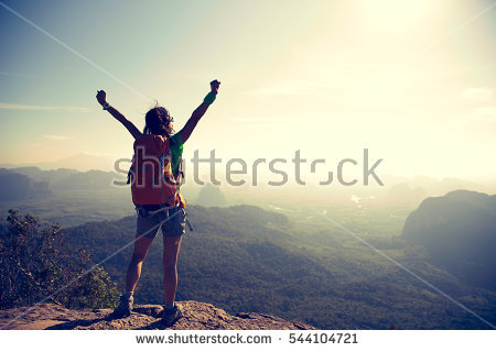 stock-photo-cheering-young-traveler-with-backpack-on-the-mountain-peak-rock-observing-locality-544104721.jpg