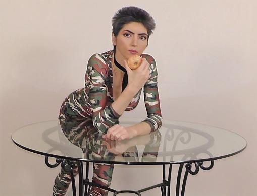 nasim-leaning-over-a-table-with-a-doughnut.jpe