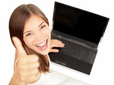 Girl-with-one-hand-on-laptop-the-other-giving-a-thumbs-up.jpg