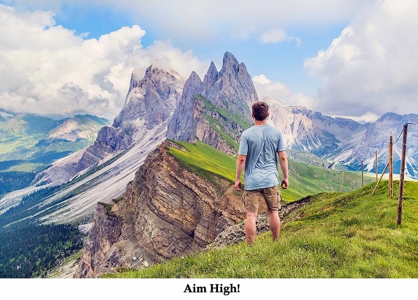 joshua-earle-117661  man in shorts looking at jagged peaks text space below aim high.jpg