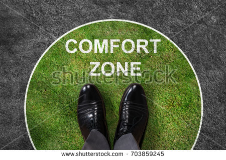 stock-photo-businessman-standing-on-green-and-gray-carpet-with-comfort-zone-text-on-it-703859245.jpg
