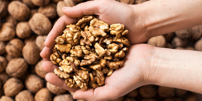 the-health-benefits-of-walnuts-holding-in-hands-700-350-1.jpg