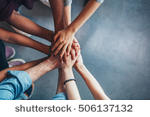 stock-photo-close-up-top-view-of-young-people-putting-their-hands-together-friends-with-stack-of-hands-showing-506137132.jpg