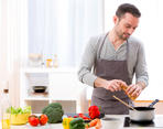 stock-photo-view-of-a-young-attractive-man-cooking-in-a-kitchen-255048322.jpg