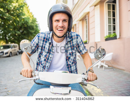 stock-photo-cheerful-young-man-in-helmet-is-riding-on-scooter-in-town-311404862.jpg