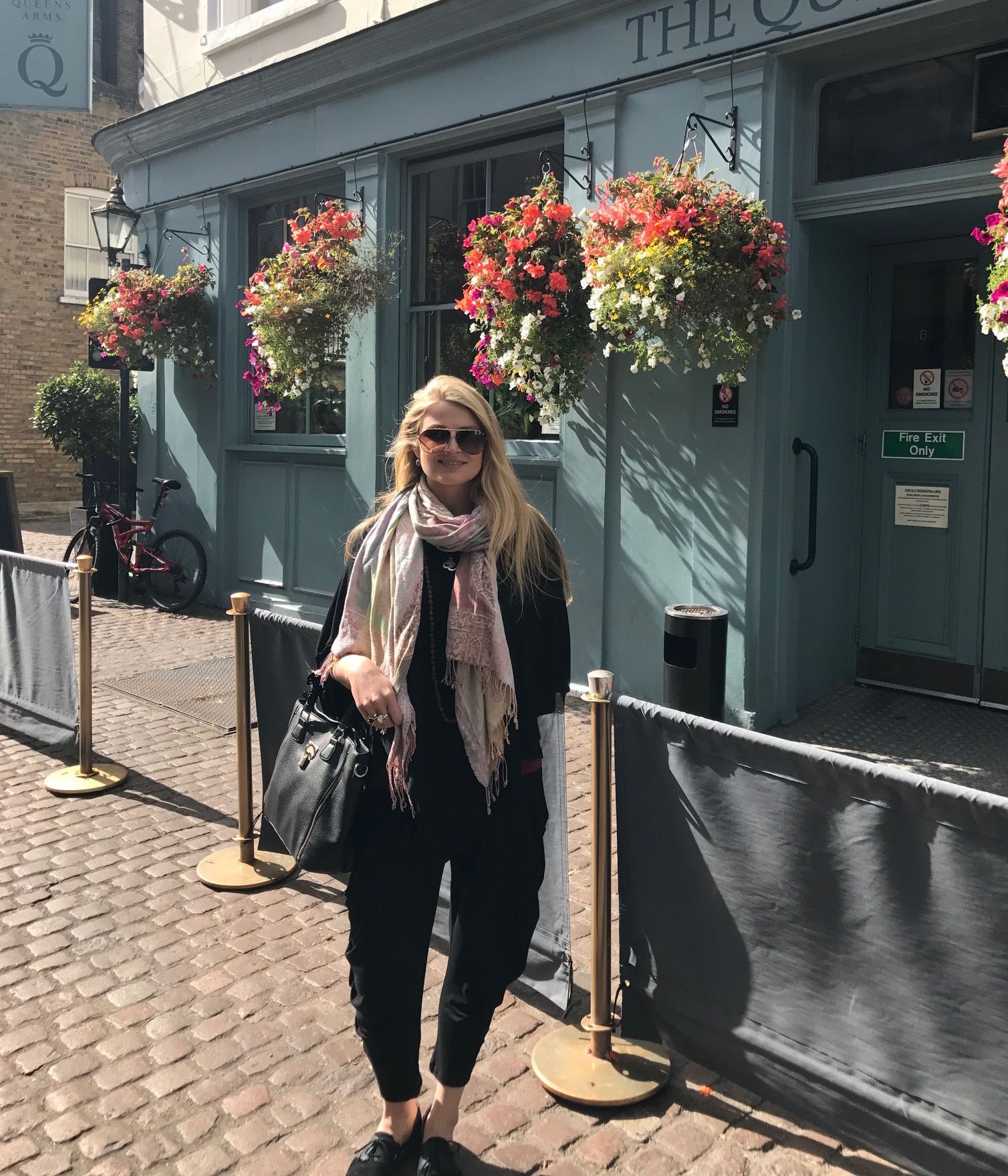 me outside pub with flowers.JPG