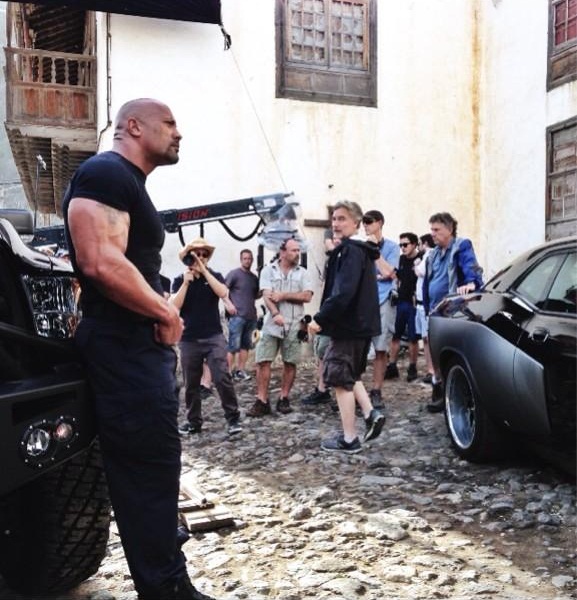Dwayne 'The Rock' Johnson tweeted out this photo of himself on the set to Fast 6 showing off his massive guns. The image came with the following note,.jpeg