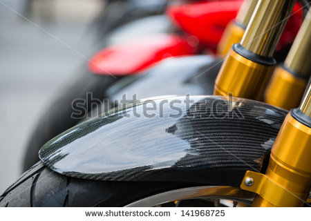 stock-photo-motorbike-detail-carbon-fiber-mud-guard-and-golden-dampers-141968725.jpg