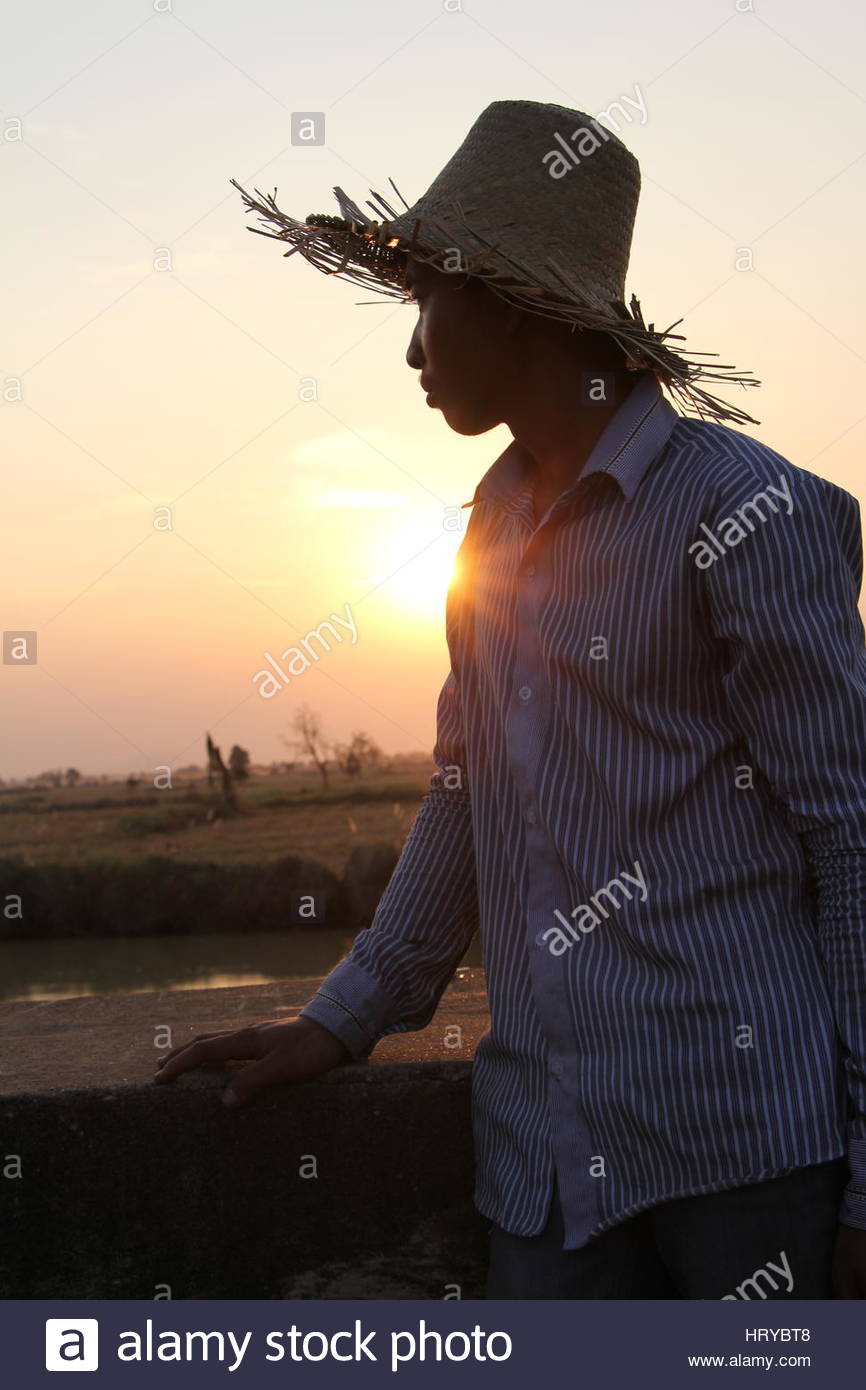 facial-side-profile-of-cambodian-farmer-at-sunset-wearing-straw-hat-HRYBT8 (1).jpg