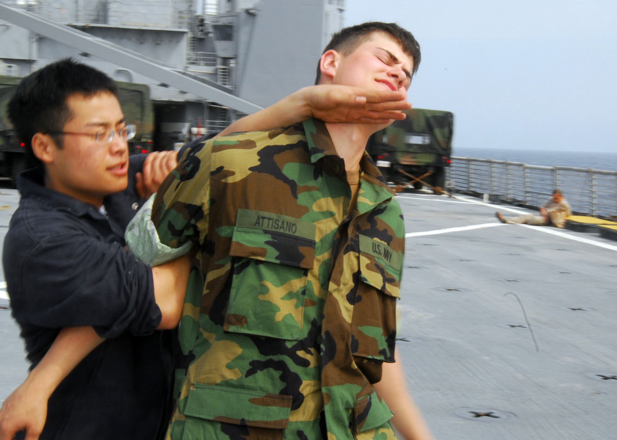 US_Navy_070311-N-4124C-023_Engineman_Fireman_Apprentice_Jimmy_S._Seechang_practices_a_restraining_maneuver_on_Seaman_Apprentice_Lawrence_L._Attisano_as_part_of_a_Visit,_Board,_Search_and_Seizure_(VBSS)_dry-fire_training_day_abo.jpg