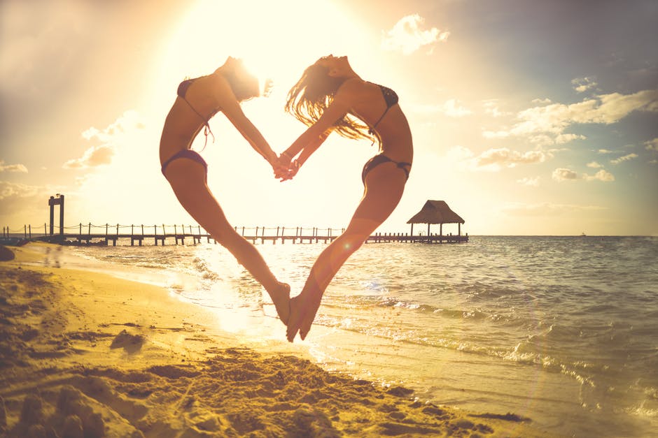 Holiday Sea Beach - 2 Girls Try to Make Heart.jpg