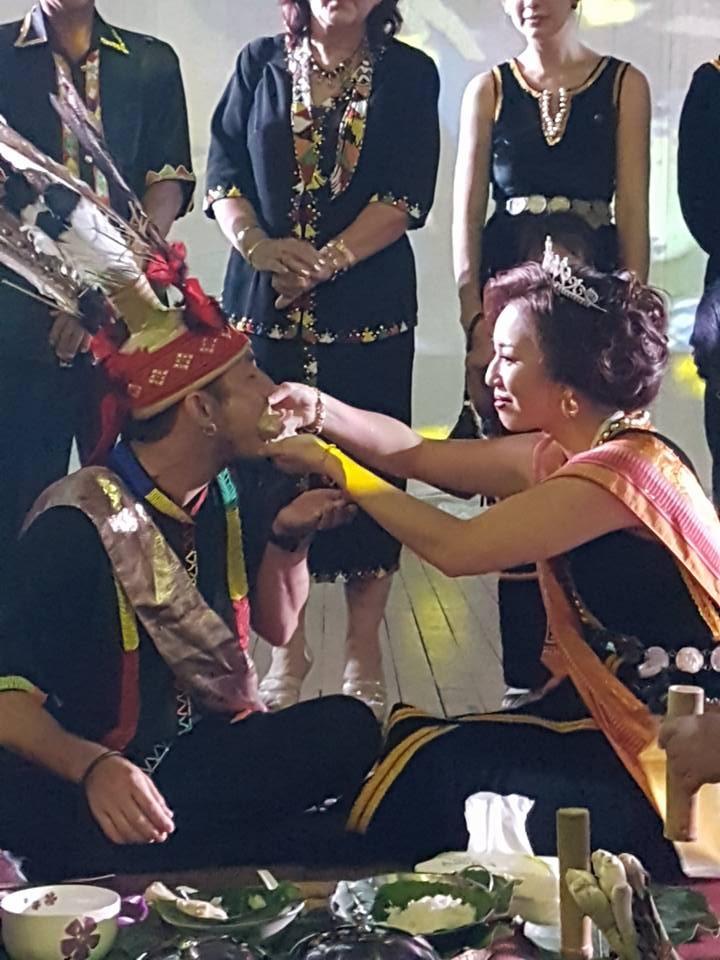 Chloe fed her husband some food at the miohon pinisi ceremony.jpg