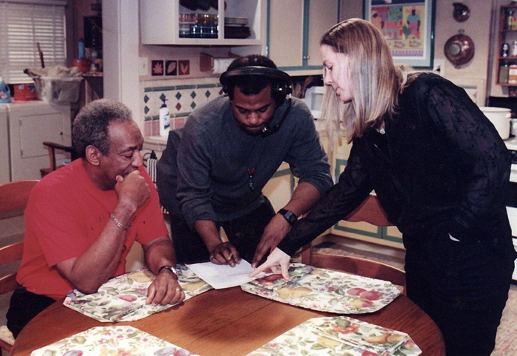 1024px-Bill_Cosby_(left)_production_assistant_(center)_Ginna_Marston_(right).jpg