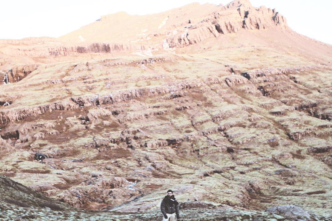 Me, Sean Yalda, posing in front of a mountain in Iceland.