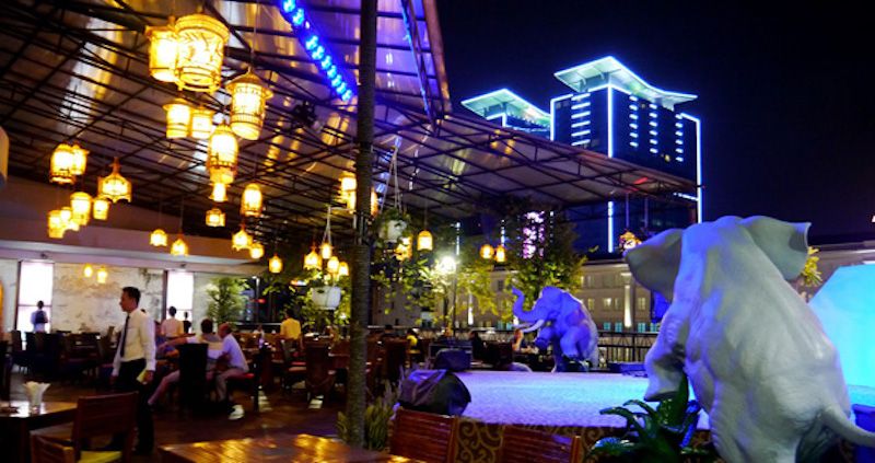 The Beautiful Garden Bar at the Rex Hotel, with the illuminated Vincom Centre in the background.jpg