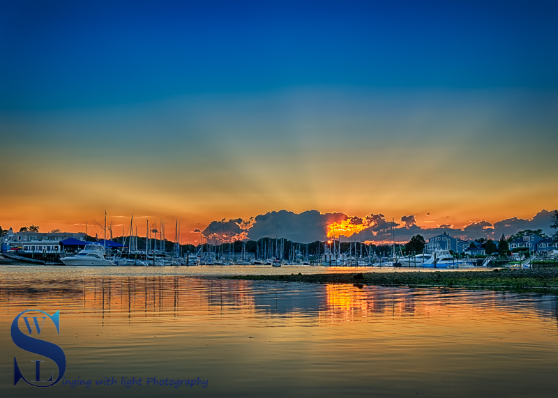 Sun setting over the harbor 25 June.jpg