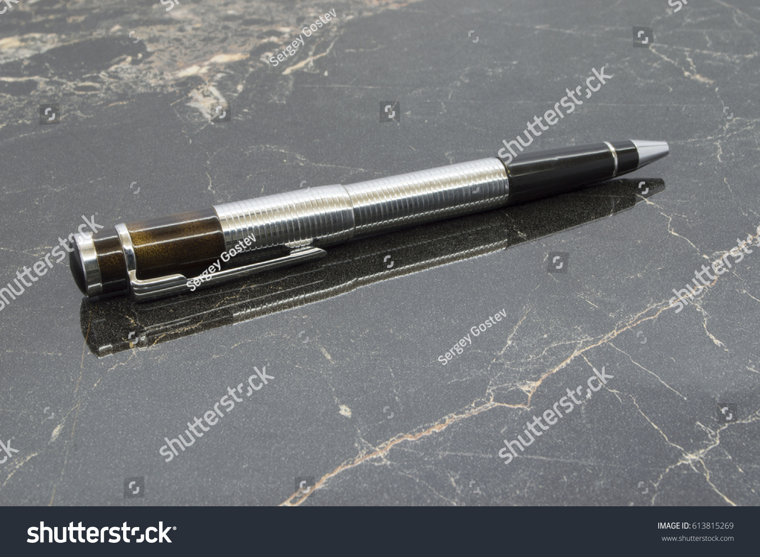 stock-photo-pen-on-the-table-613815269.jpg