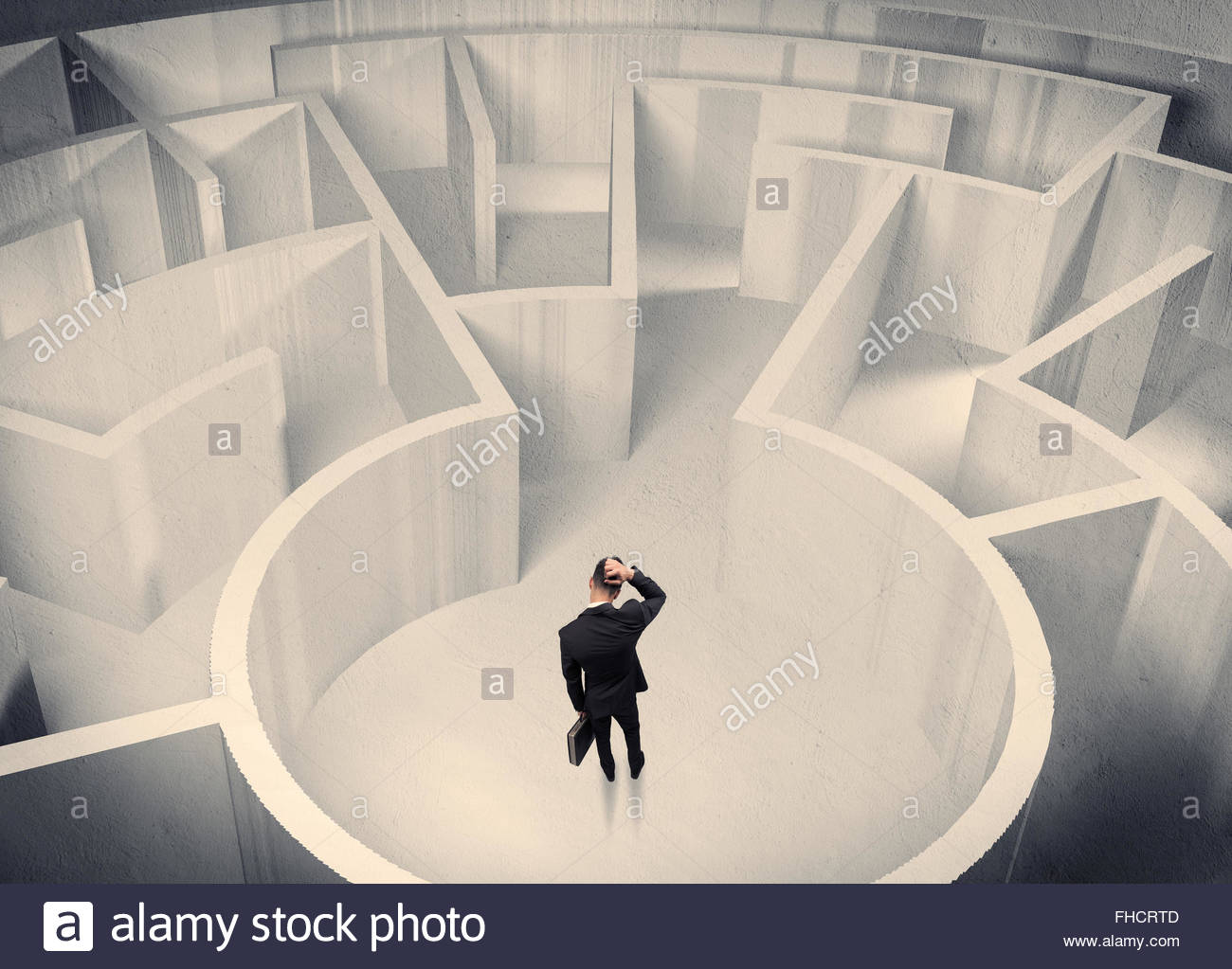 business-person-standing-in-maze-center-FHCRTD.jpg