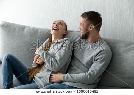 stock-photo-young-happy-couple-having-fun-talking-laughing-relaxing-at-home-on-couch-boyfriend-embracing-1006618492.jpg