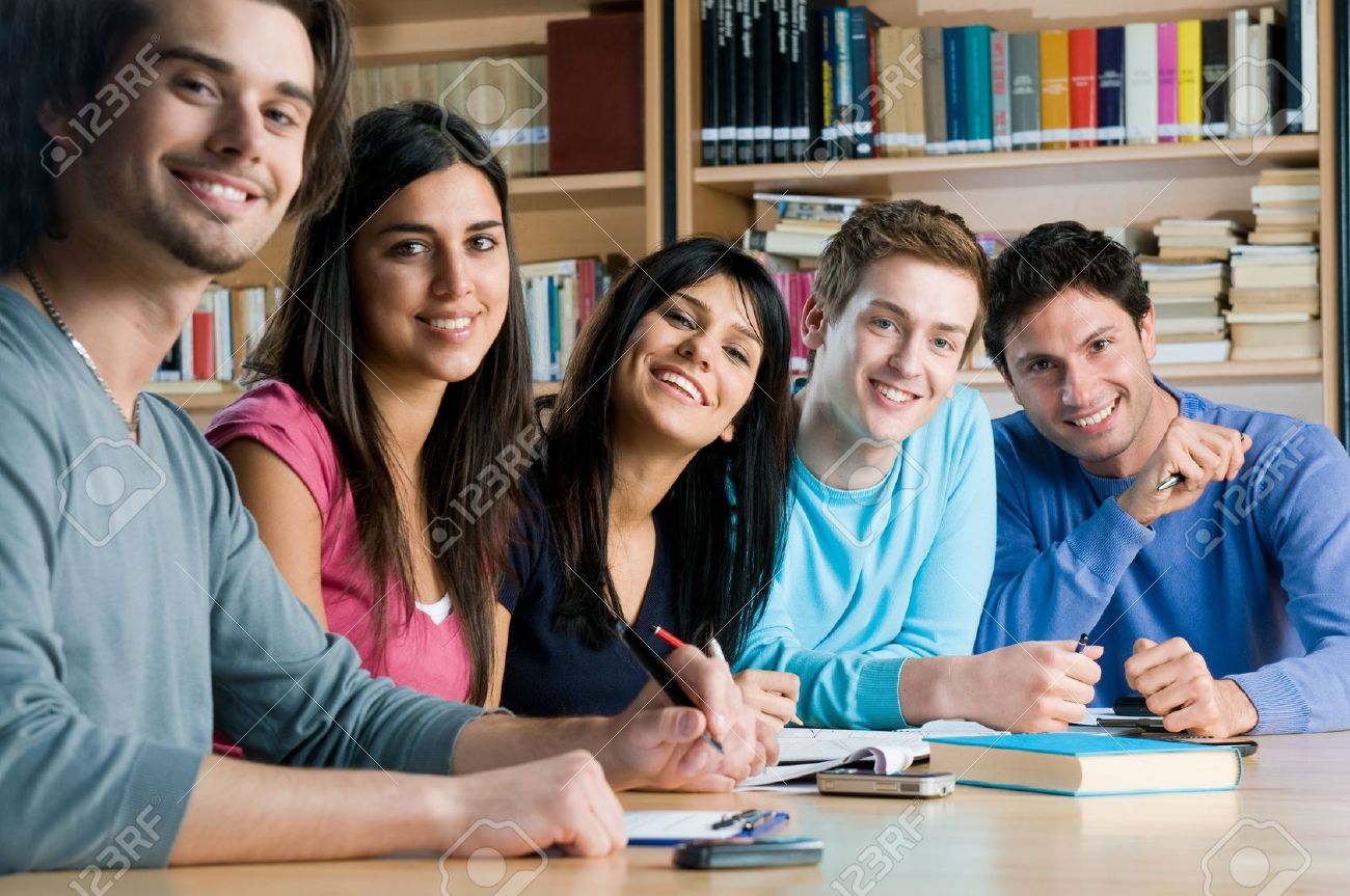 8236164-happy-group-of-young-students-studying-together-in-a-college-library-and-looking-at-camera-smiling.jpg