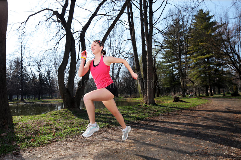 panning-shot-female-runner-running-19035708.jpg