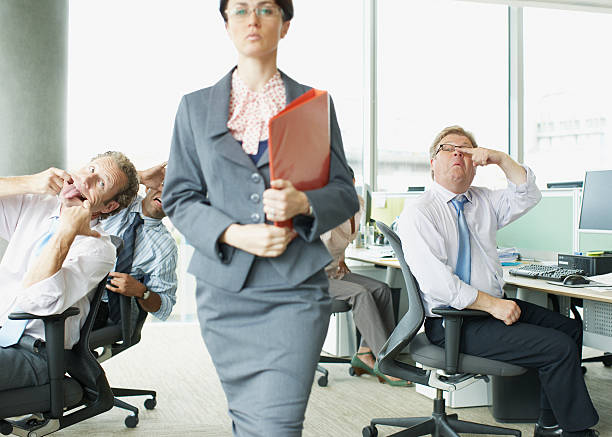 businesspeople-making-face-at-boss-in-office-picture-id85406131.jpg