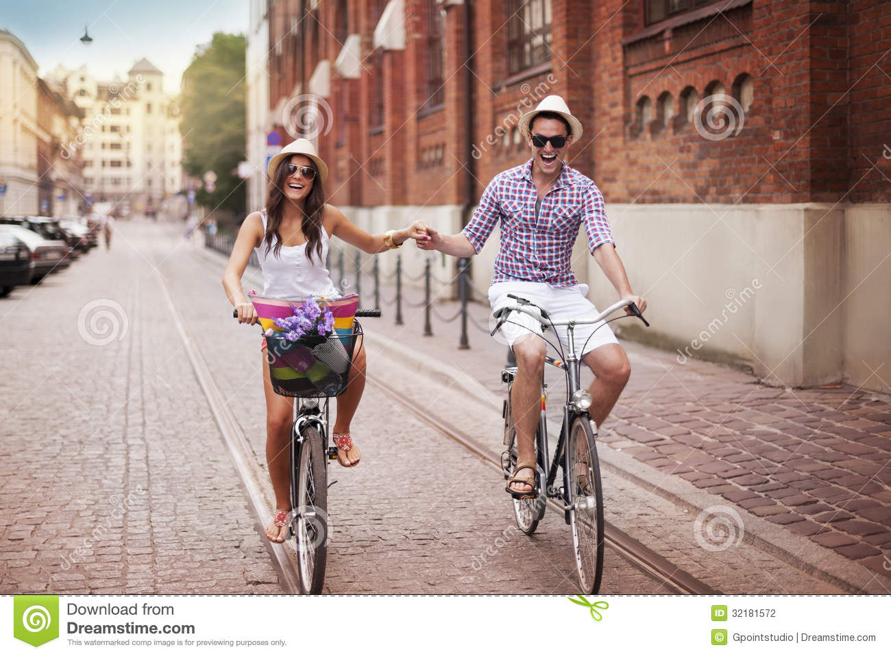 riding-bike-happy-young-couple-holding-hands-32181572.jpg