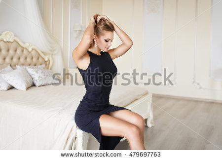 stock-photo-beautiful-young-blonde-girl-in-a-sexy-black-dress-479697763.jpg
