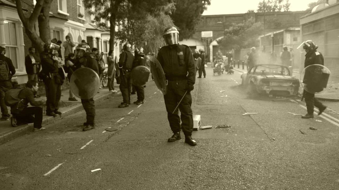 8822665441 - police in riot gear form human cordon around the.jpg