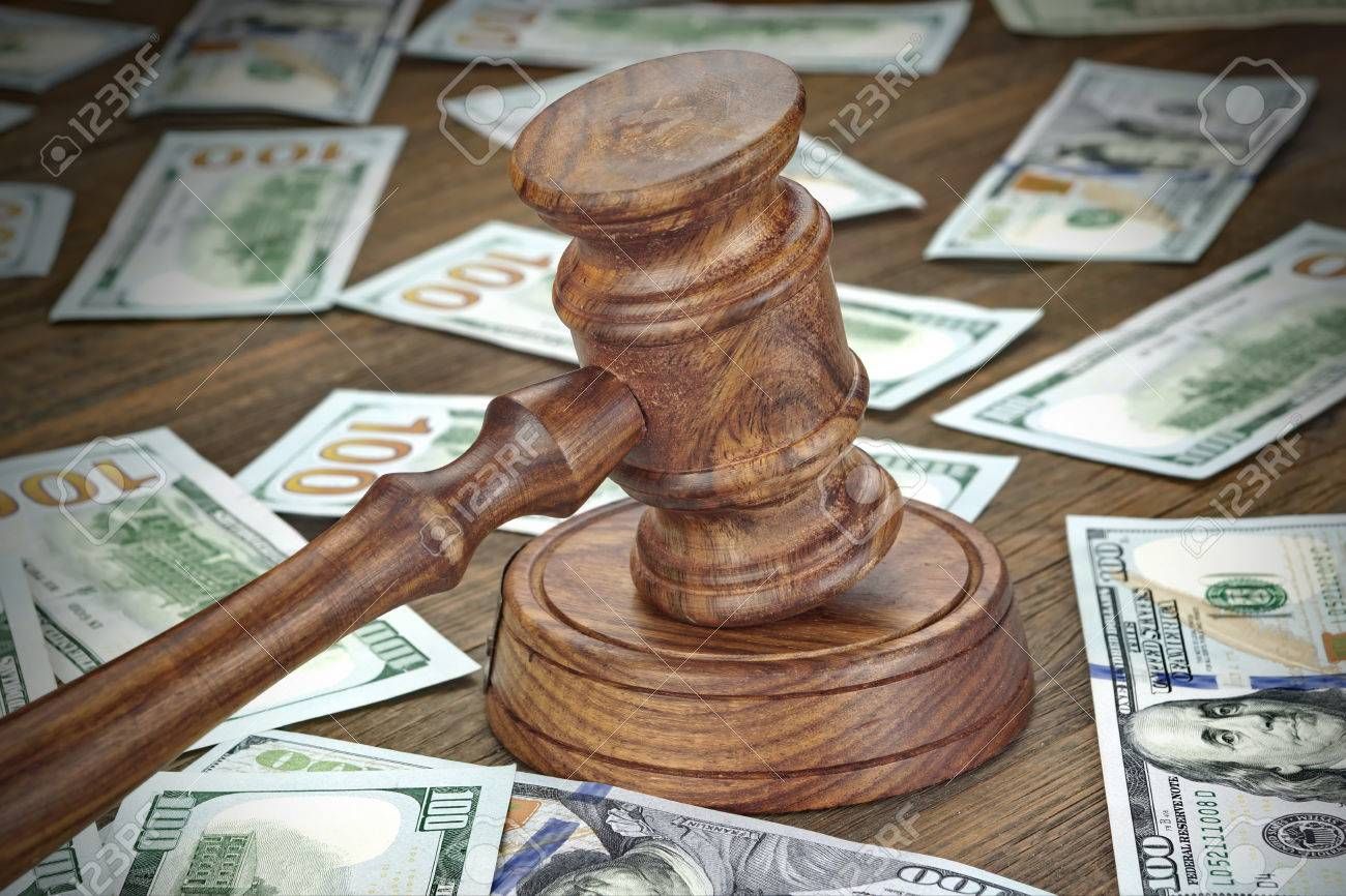 60412804-financial-crime-or-fraud-or-auction-concept-image-with-judges-gavel-or-auction-hammer-and-money-stac.jpg