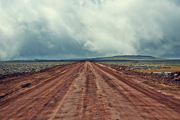 the-highest-all-year-dirt-road-and-a-stormy-sky-picture-id605569013.jpg