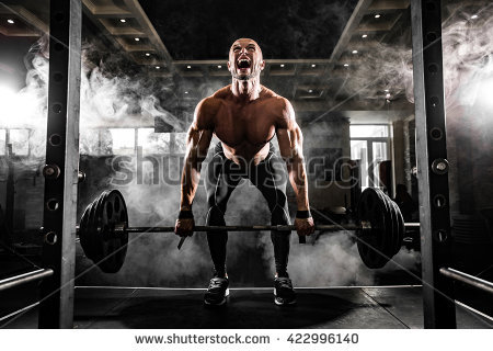 stock-photo-young-shirtless-man-doing-deadlift-exercise-at-gym-screaming-for-motivation-422996140.jpg