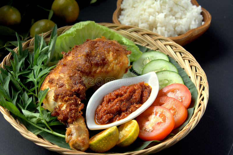 ayam-penyet-set-indonesian-cuisine-fried-chicken-dish-consisting-fried-chicken-served-sambal-slices-66006757.jpg