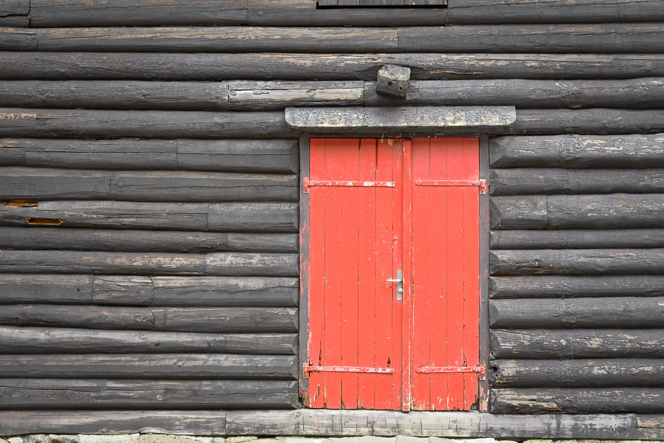 Red door in a black barn on the Faroe Islands