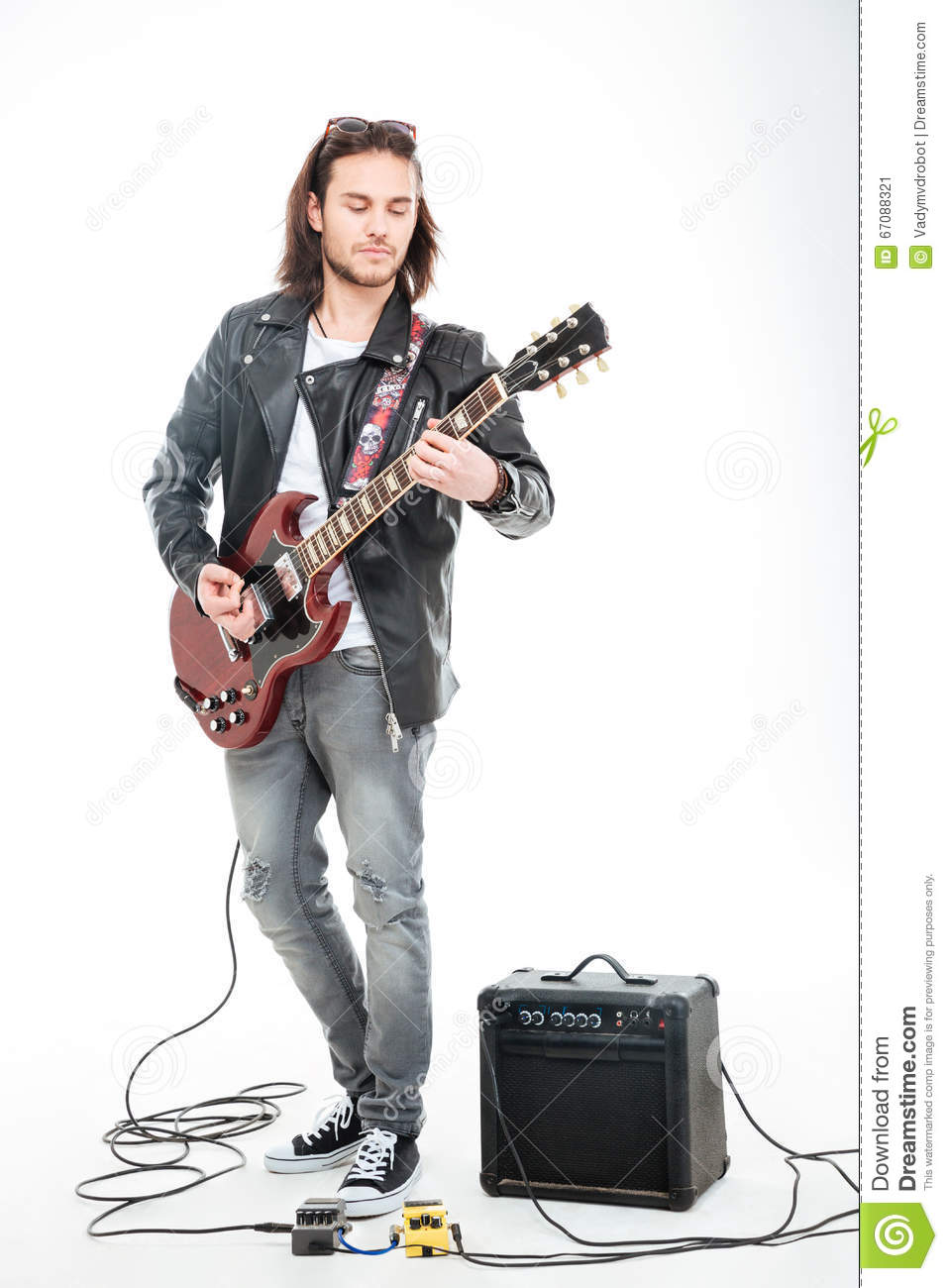 concntrated-young-male-guitarist-playing-electric-guitar-using-amplifier-over-white-background-67088321.jpg
