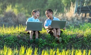 Kids laughing on laptops