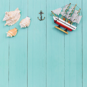 top-view-of-seashells-and-toy-ship_23-2147656261.jpg